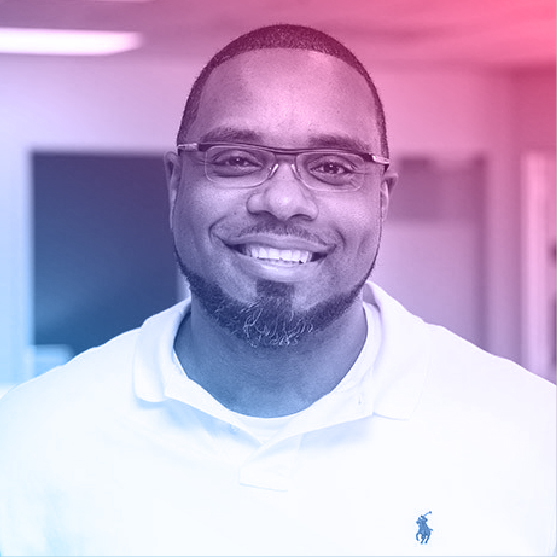 Portrait of Elrick. He has short hair and a short beard.